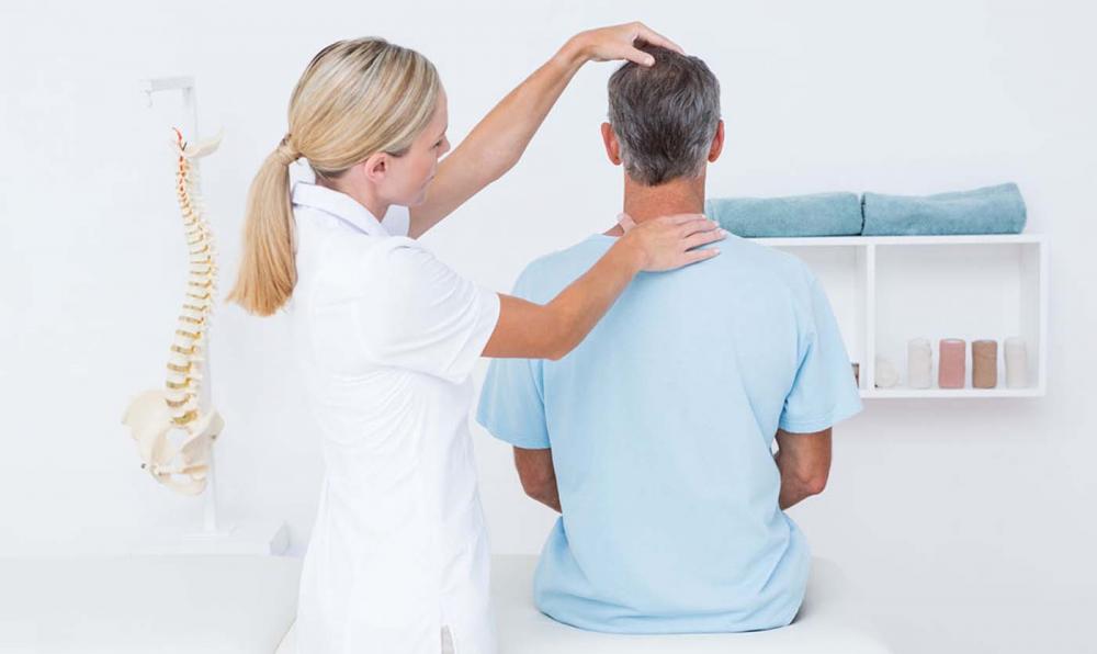 Chiropractor seeking pinched nerve in patient